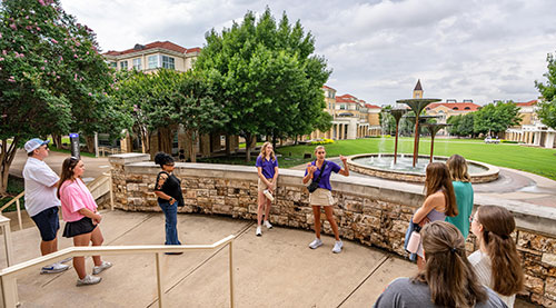 A TCU student leads a campus tour