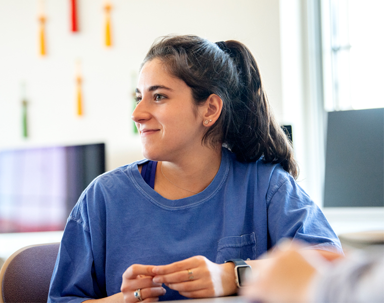 Female TCU student smiling in class